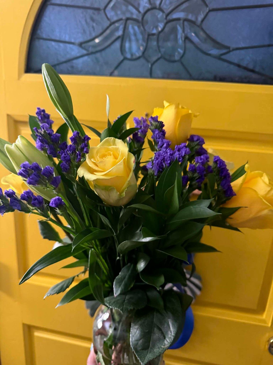 Birthday flowers — yellow roses with purple accents for MereBear